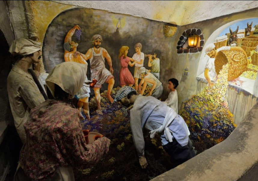 exhibits show men and women crushing grapes at 'Koutsoyannopoulos Wine Museum'